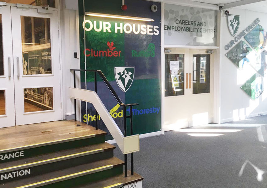 A transformed reception area featuring core values displays, house boards and directional signage.