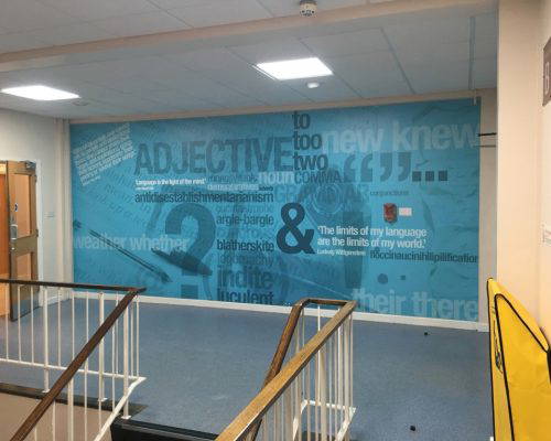English wall art installed in a corridor featuring terminology, quotes and literary devices by Design for Education