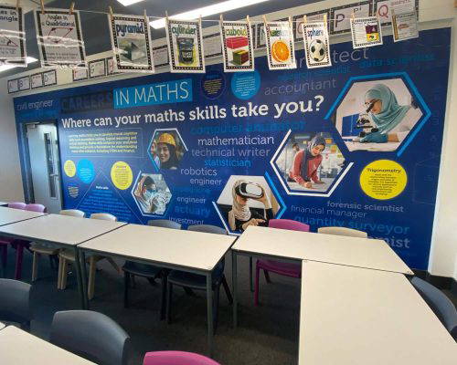 Classroom with Careers in Maths poster. Math skills lead to jobs: engineer, statistician, accountant, scientist.