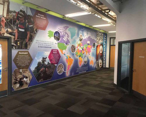 School wall art featuring a vibrant world map and career profiles. Designed, manufactured and installed by Design for Education