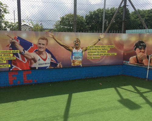Outdoor Sports-themed Wall Art School wall art featuring inspiring athletes, such as Kelly Holmes, for sports field. Designed, manufactured and installed by Design for Education