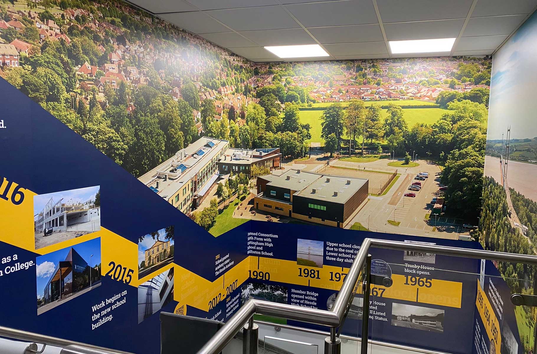 A bespoke heritage stairwell display featuring secondary school wall art at The Hessle Academy.