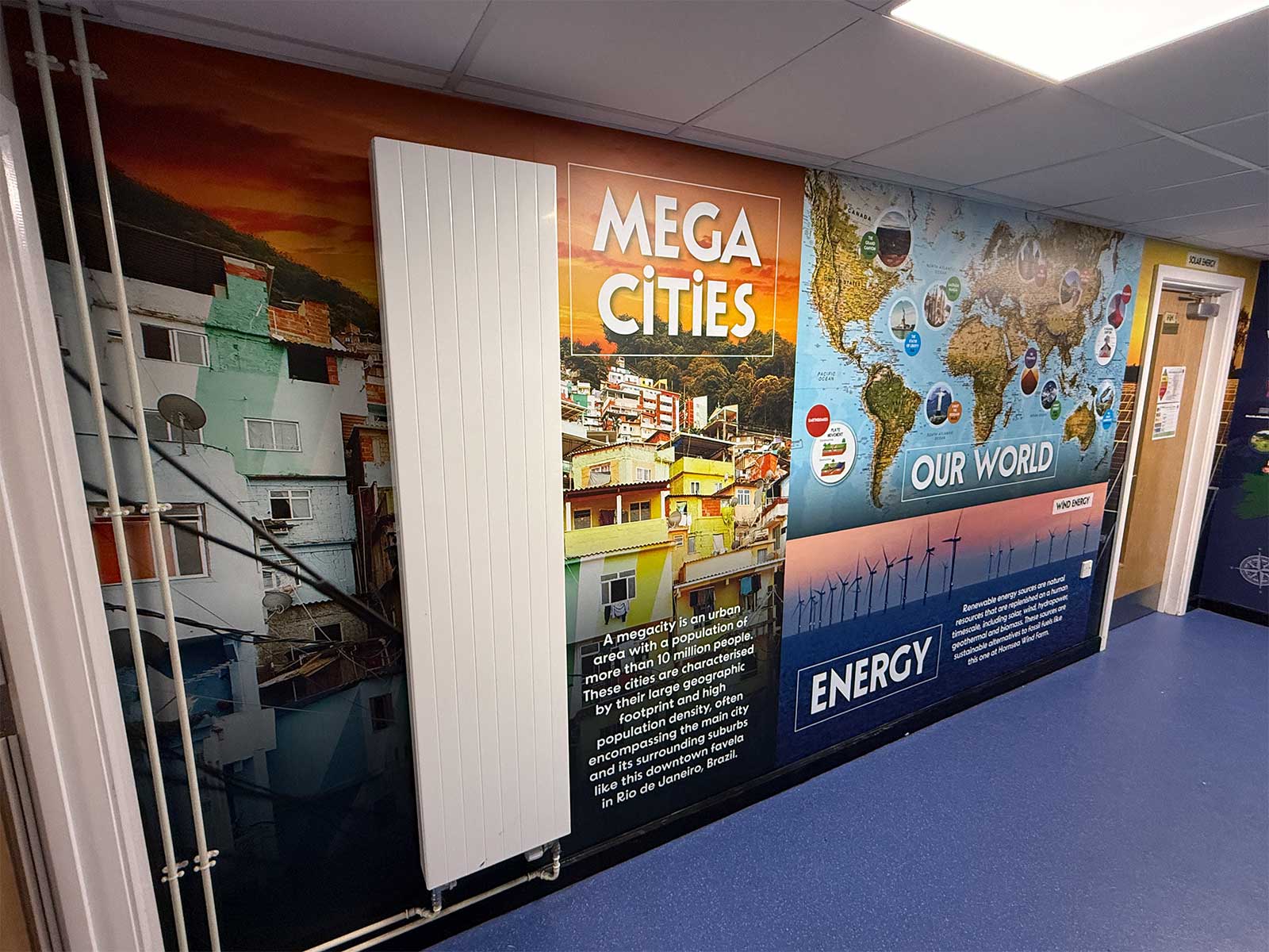 Close-up of educational wall art showing GCSE-level geography terminology and curriculum-linked graphics.