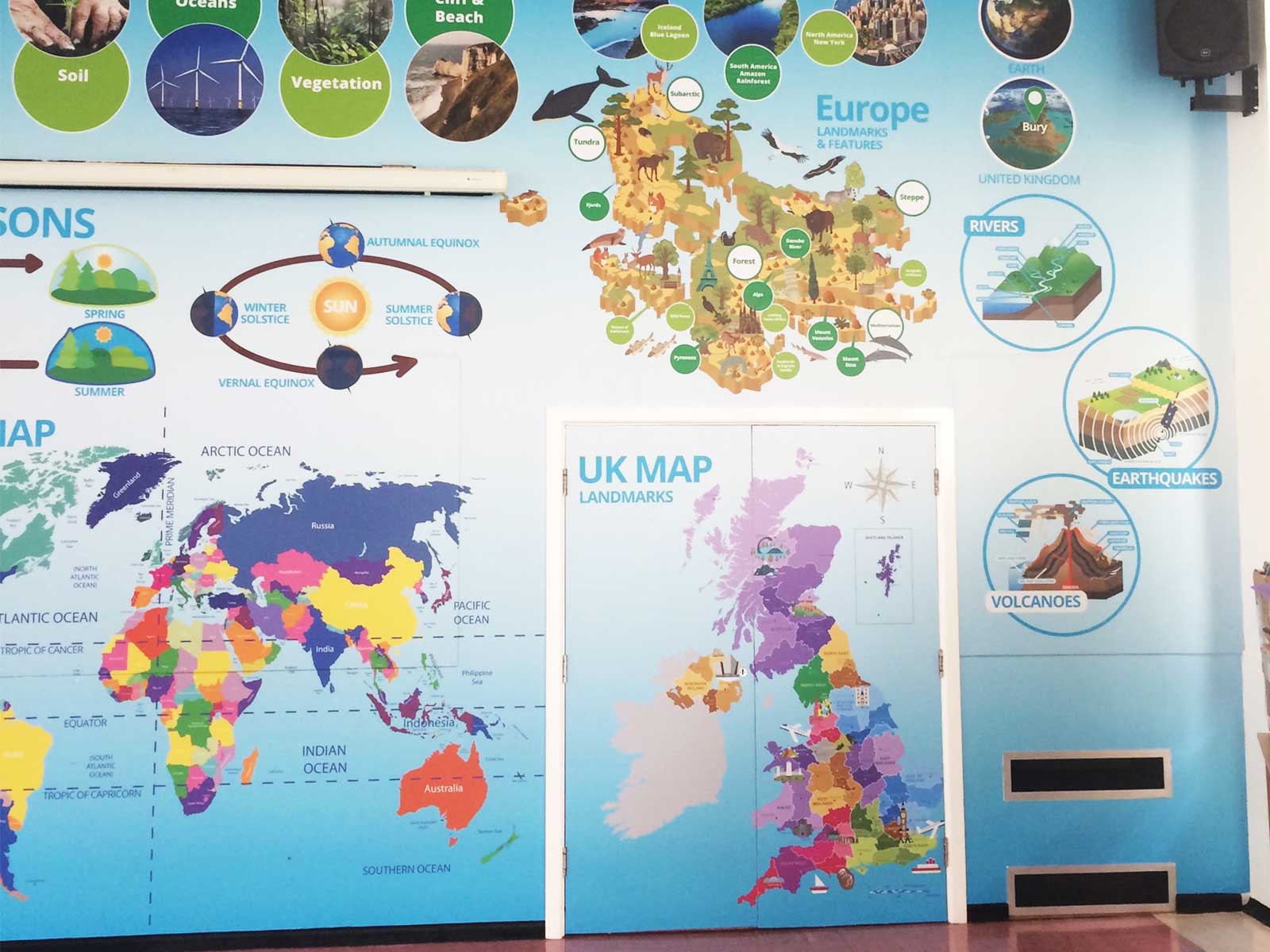 Inspiring learning environment design in a Bury school hall using curriculum-linked geography wall art.
