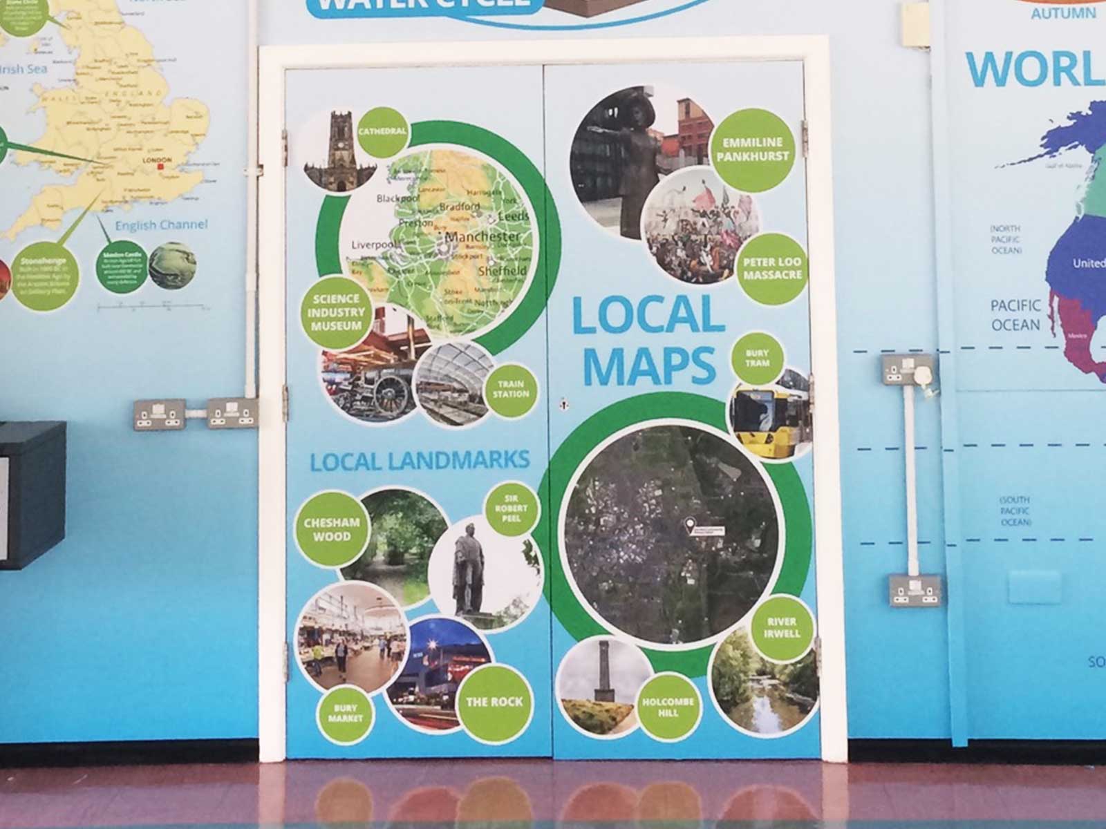 Full-coverage hall displays including door wraps for an immersive geography learning environment.
